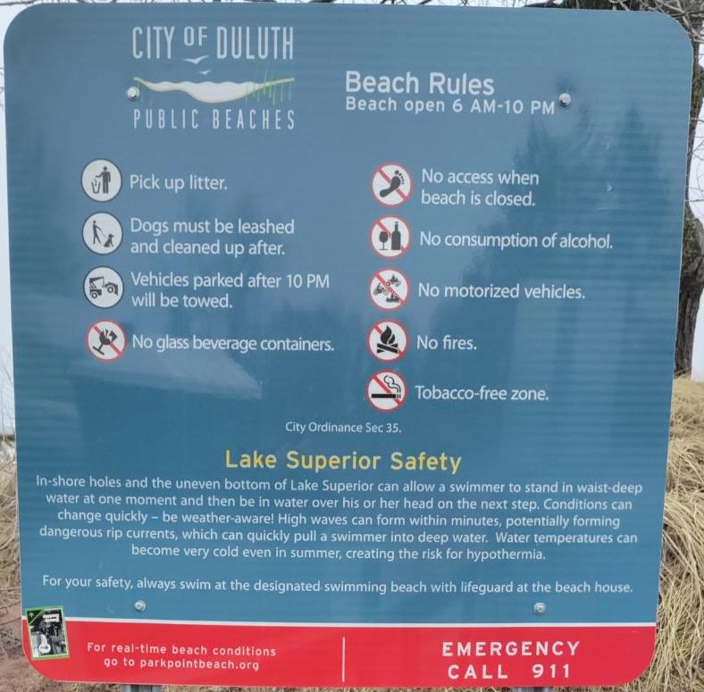 A sign displays beach rules in Duluth, Minnesota.